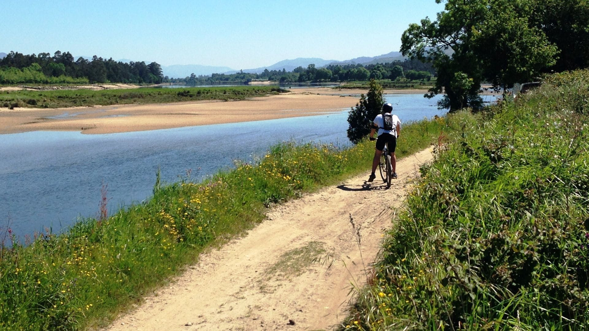 Ciclista su un sentiero lungo il fiume - campagna del Minho - Portogallo